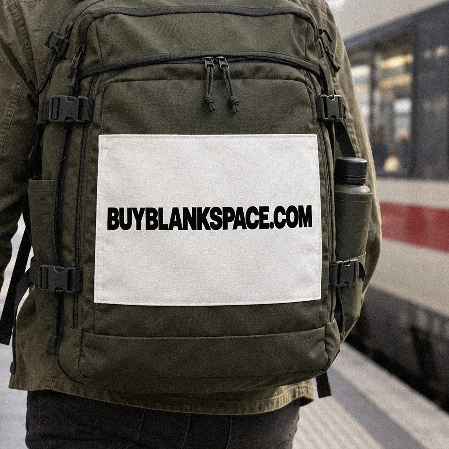 Backpack displaying BUYBLANKSPACE.COM while traveling by train